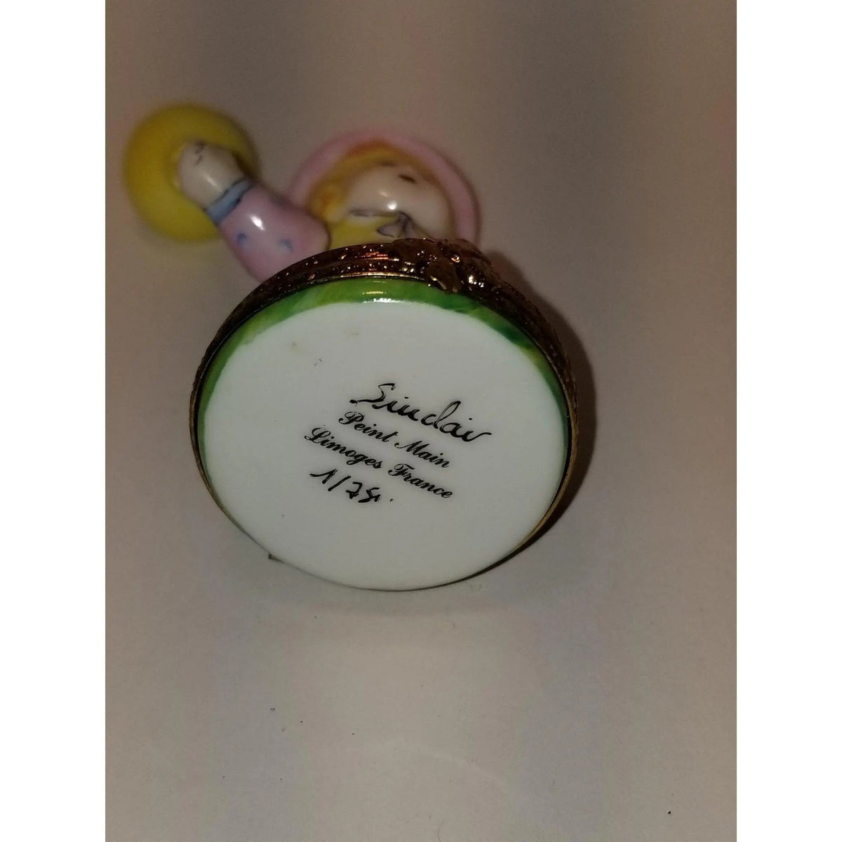 Every brushstroke by hand on the Baby Girl Yellow Balloon 1 of 500 Limoges box from France