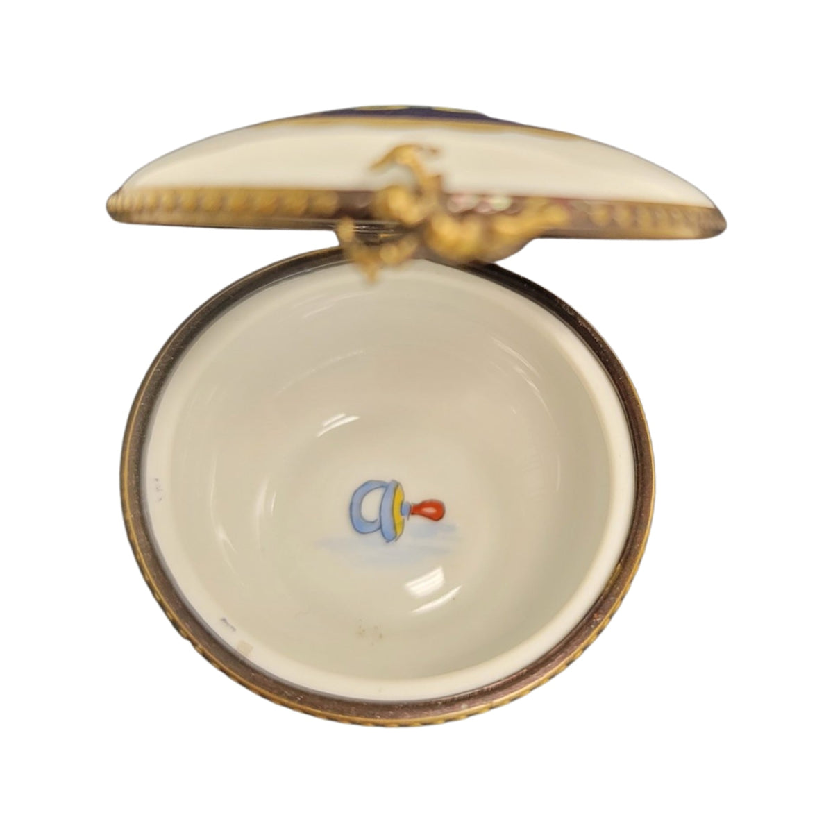 Painted details on the Baby Round Limoges box, French art in miniature