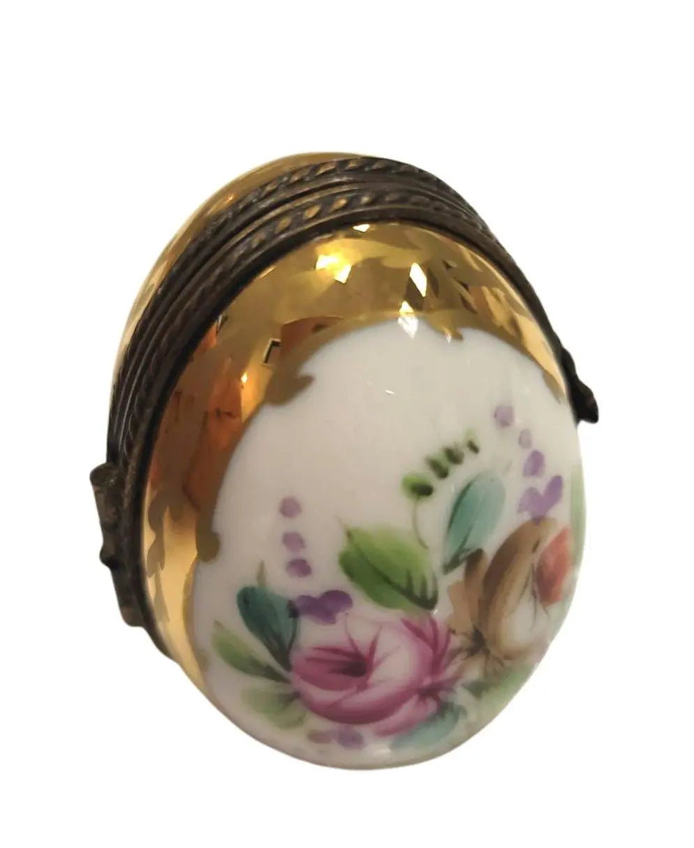 Fine French craftsmanship on the Flowered Egg Oval Picture Frame Limoges box, painted by hand