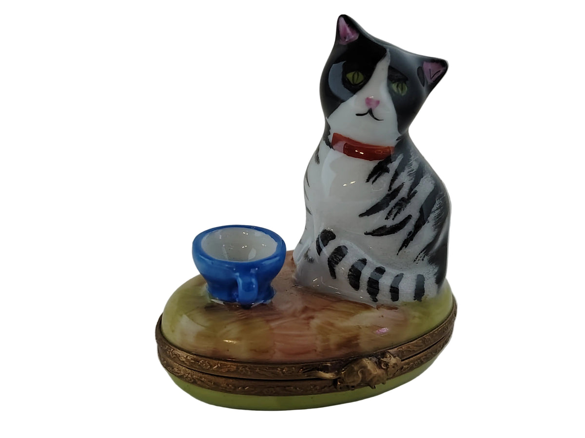 Limoges Boutique presents the Cat with Blue Cup, a genuine Limoges box painted by hand in France