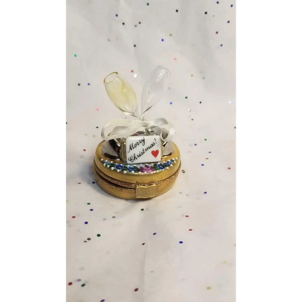 Fine art lovers will admire this Merry Christmas Champagne Glasses Limoges box