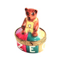 Limoges Boutique presents the Mini Teddy Bear on Oval, a genuine Limoges box painted by hand in France