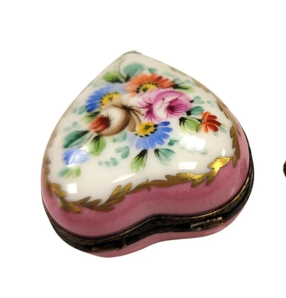 Fine art lovers will admire this Pink Heart Perfume Bottle Inside Limoges box