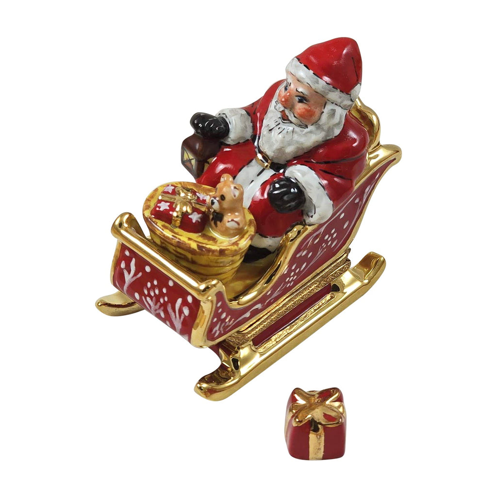 Santa in Red Sleigh with Removable Present Limoges Box, a hand-painted Limoges porcelain gift