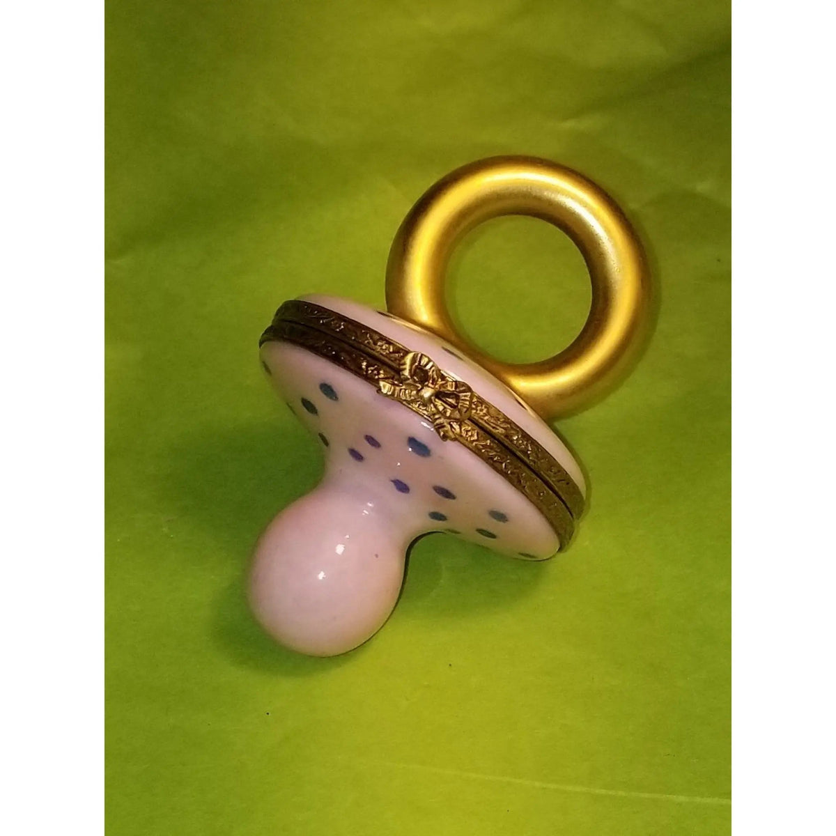 Painted details on the Pink Pacifier Baby Limoges box, French art in miniature