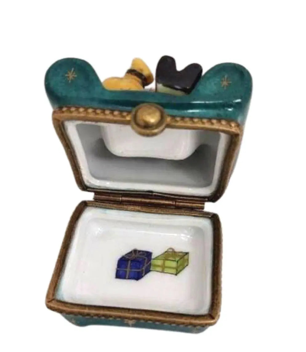 Fine French craftsmanship on the Santa Claus with Bag on Green Christmas Chair Limoges box, painted by hand