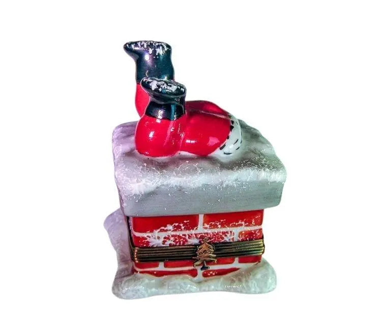 Limoges Boutique presents the Santa Crawling down Chimney, a genuine Limoges box painted by hand in France