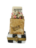 Limoges Boutique presents the Shopping Bag with Newspaper, a genuine Limoges box painted by hand in France