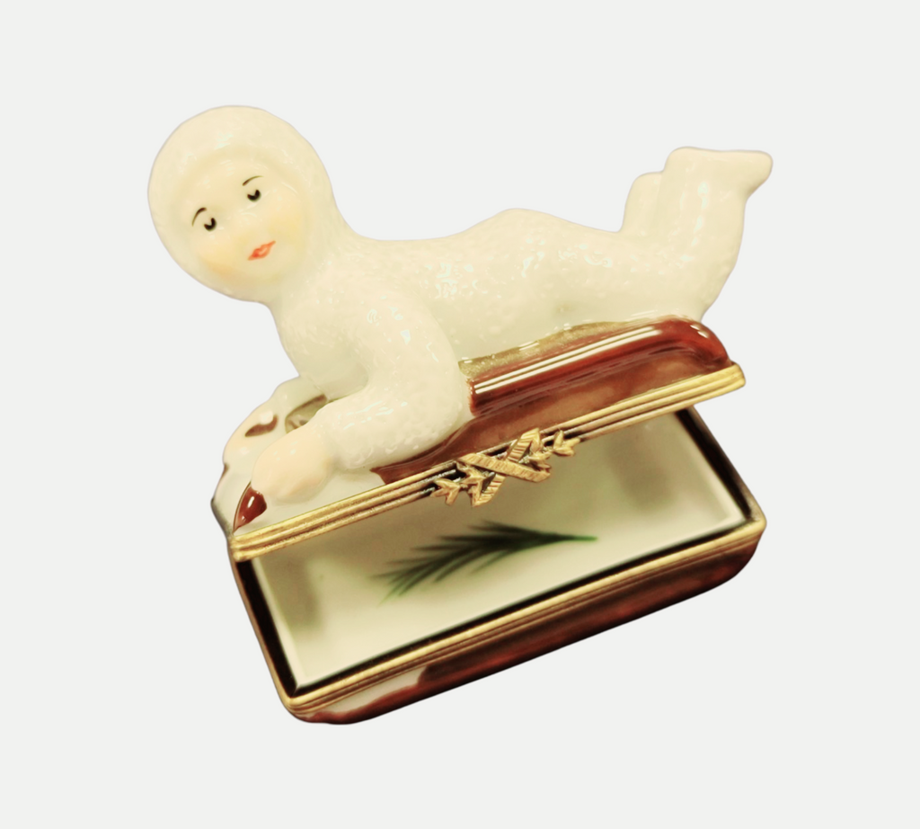 A thoughtful gift for Francophiles: the Snow Baby Kid on Sled Winter Sleigh Limoges box