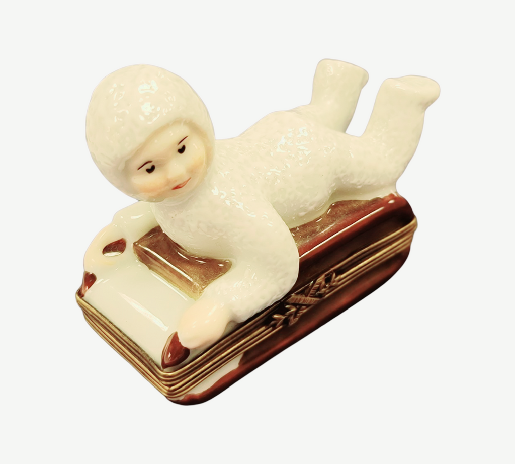 Artisan-painted Snow Baby Kid on Sled Winter Sleigh Limoges box from France, a cherished collectible