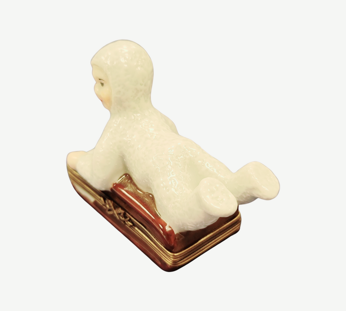 The painter's artistry shows on this Snow Baby Kid on Sled Winter Sleigh Limoges box