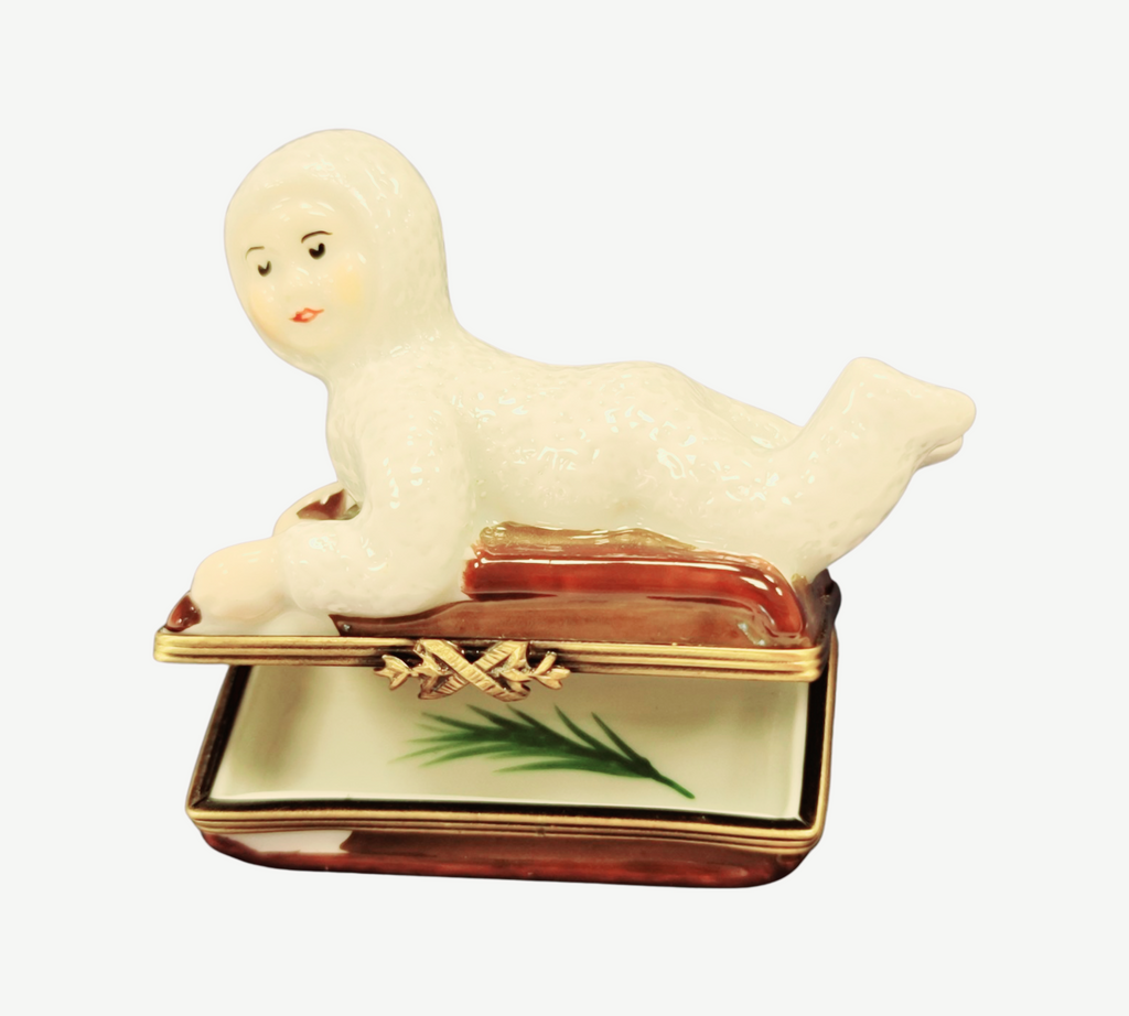 Gift idea for someone who loves France: Snow Baby Kid on Sled Winter Sleigh Limoges box