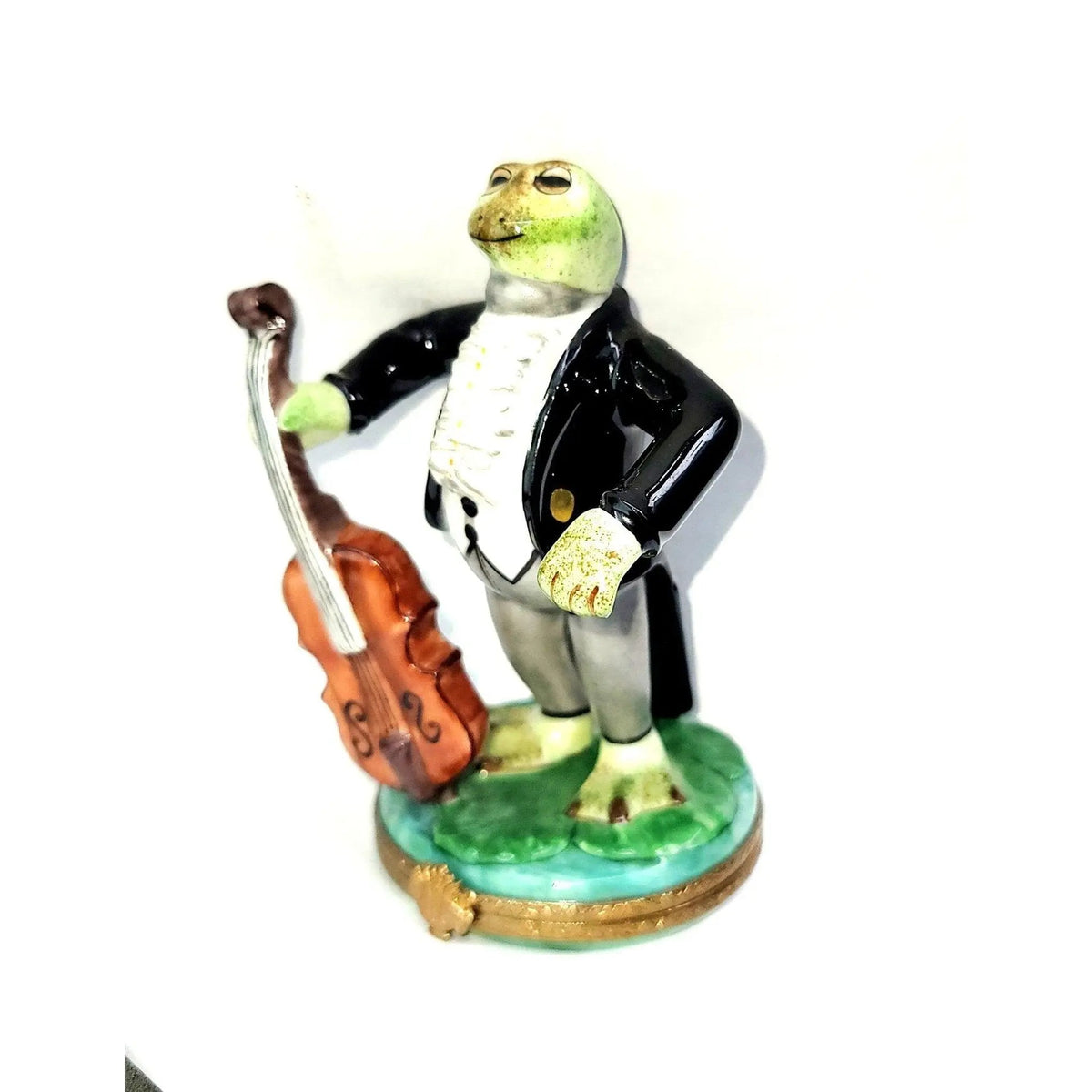 Limoges Boutique presents the Tuxedo Frog with Cello, a genuine Limoges box painted by hand in France