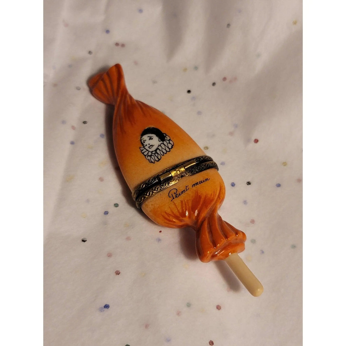 Every brushstroke by hand on the Sweet Candy Lollipop Porcelin Orange Clown Wrapping Limoges box from France