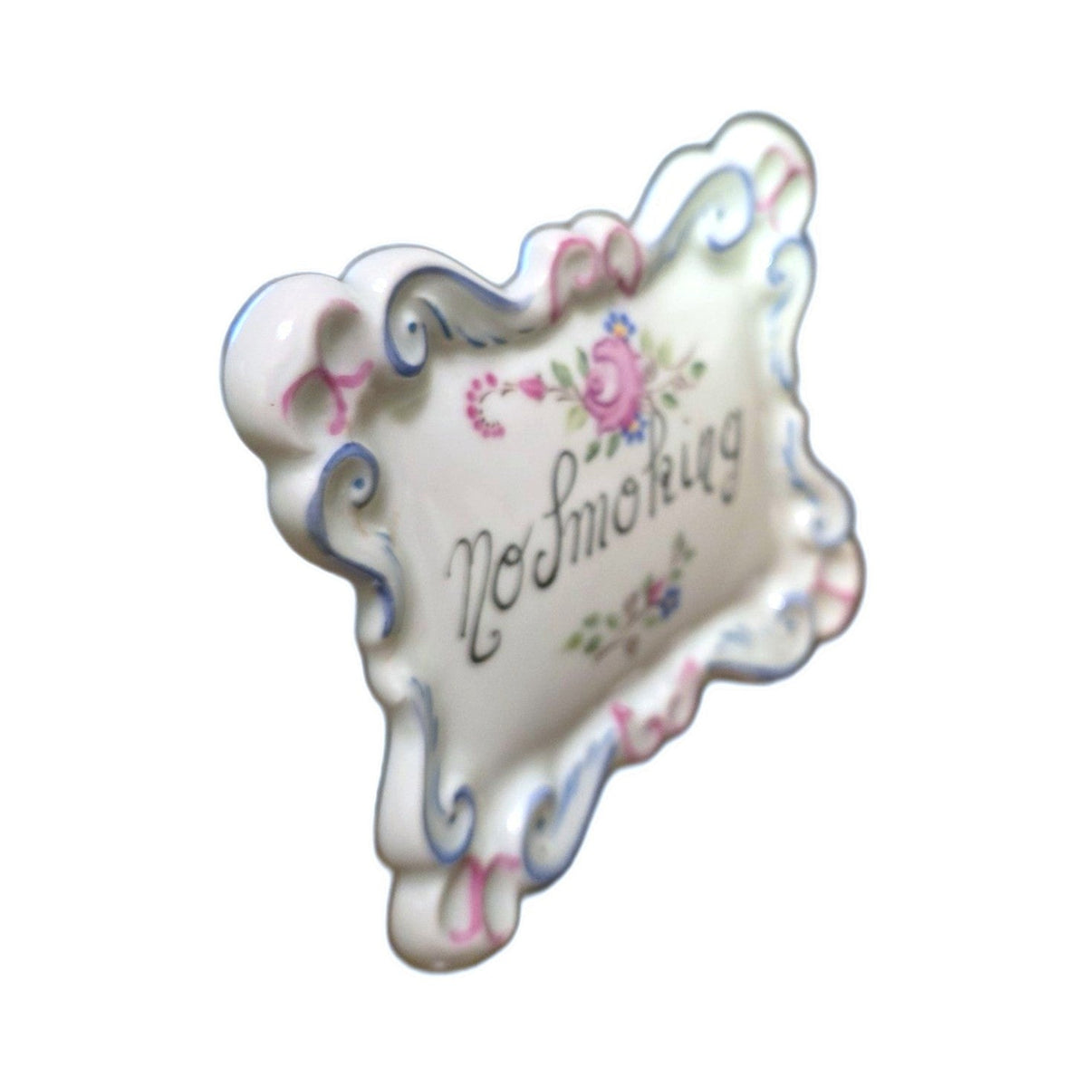 Angled view of the No Smoking Limoges plaque showing the raised scrollwork