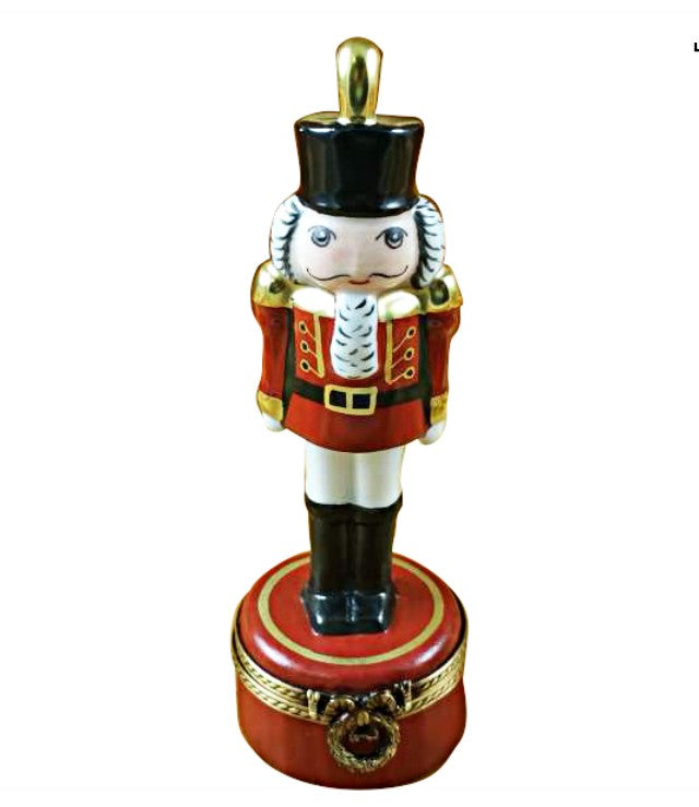 Nutcracker with Plume on Red Base Limoges Box, a hand-painted Limoges porcelain gift
